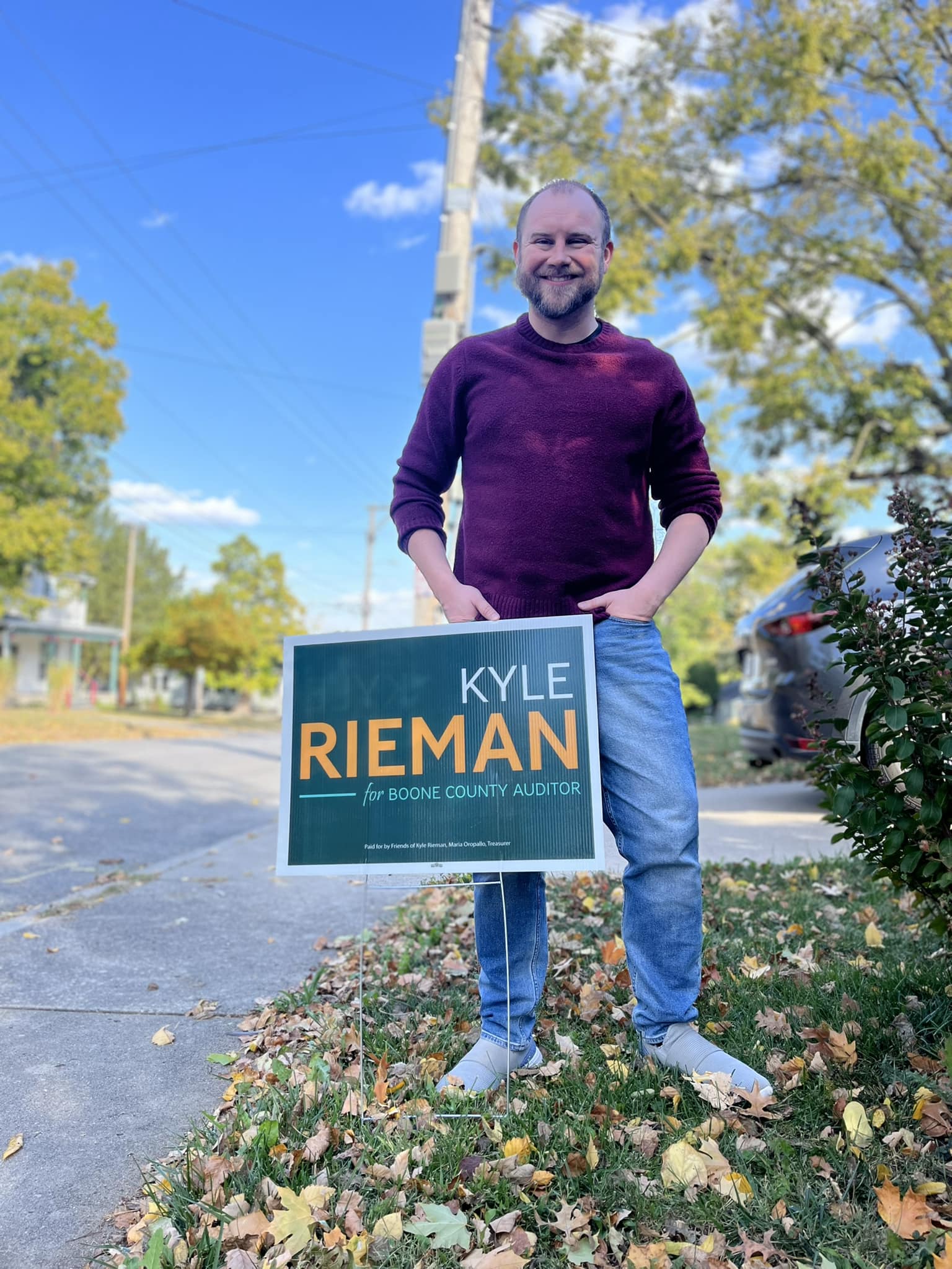 Kyle Rieman with a campaign yard sign in a Boone County neighborhood